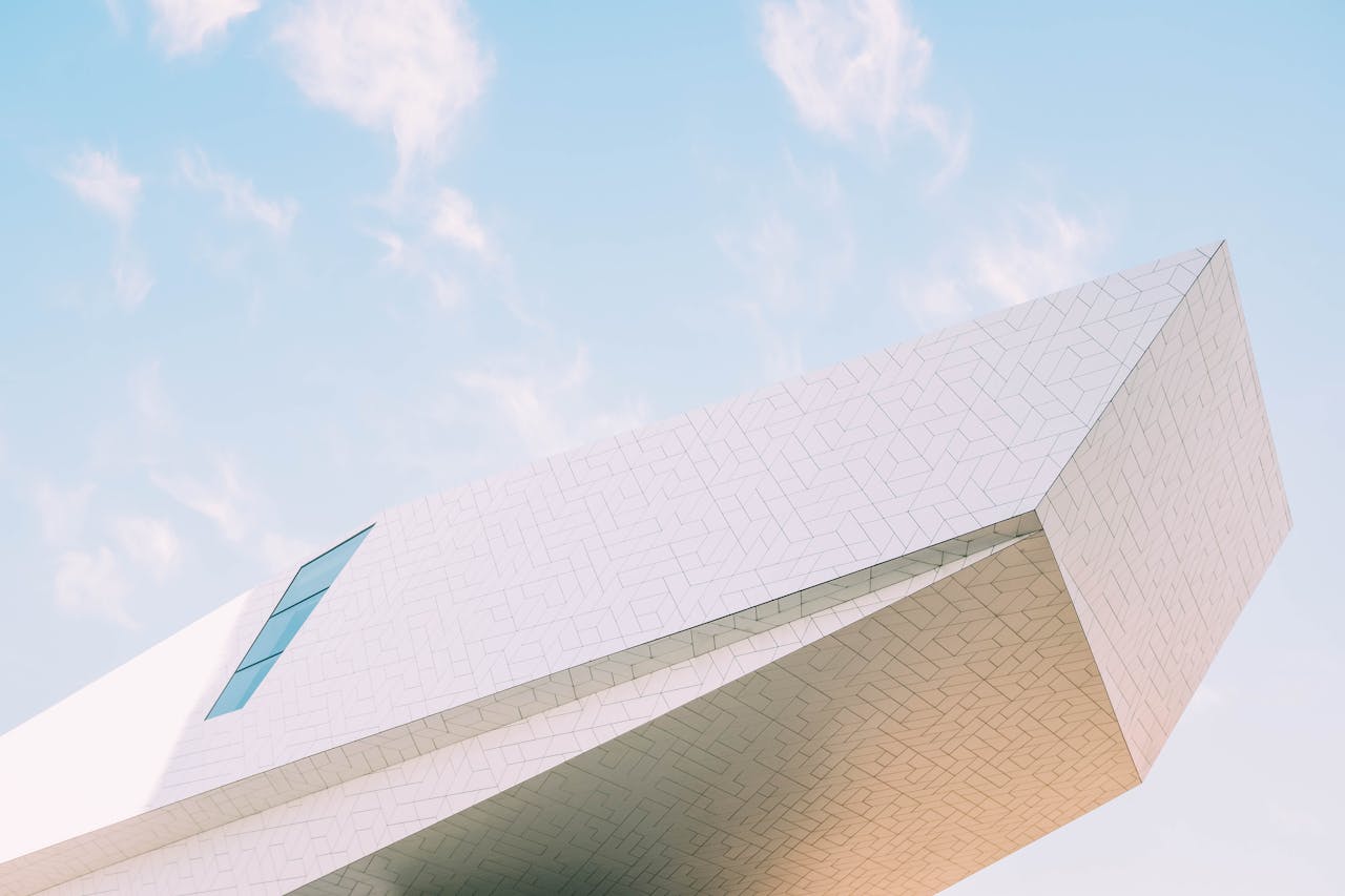 Abstract shot of modern architecture against a blue sky, highlighting geometric design.